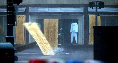 A sheet of plywood is blown down the street during Hurricane Katrina