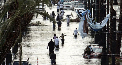 Hurricane Katrina survivors wade through a flooded street