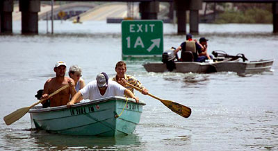 Hurricane Katrina survivors transport themselves with boats
