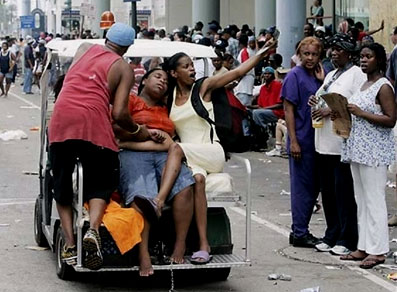 A Hurricane Katrina survivor is transported after she collapsed