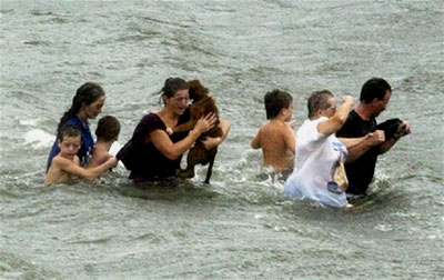 A family wades through the flood water