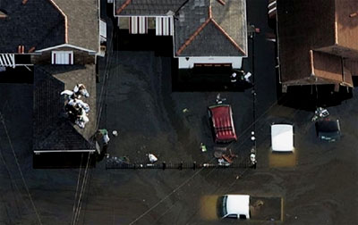 A group of Hurricane Katrina survivors sit on a rooftop awaiting rescue